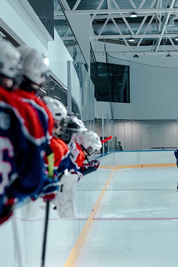 équipe sportive hockey sur glace casque protection épaule rouge sur patinoire nuit lumière led